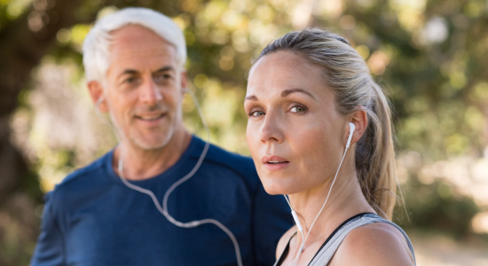 Woman running with headset and man in background